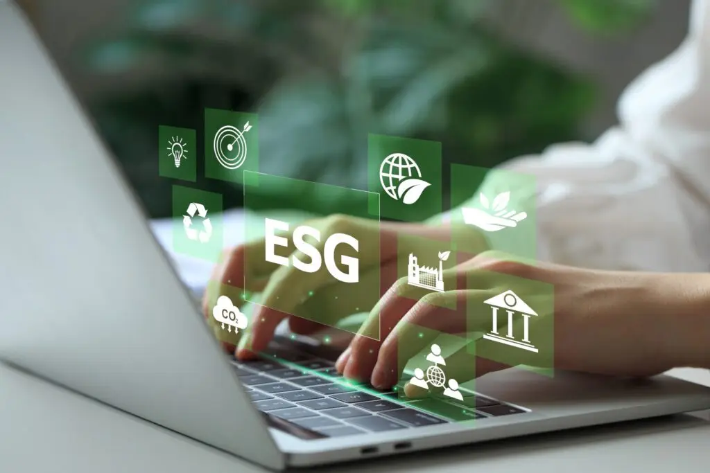 Woman working on laptop computers with ESG icons surround.